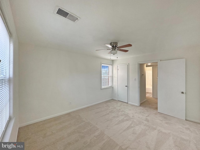 carpeted empty room with ceiling fan