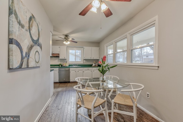 dining space featuring wood finished floors and baseboards