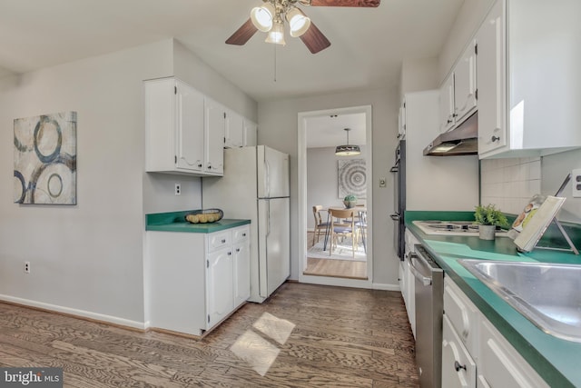 kitchen featuring under cabinet range hood, white cabinets, wood finished floors, and freestanding refrigerator