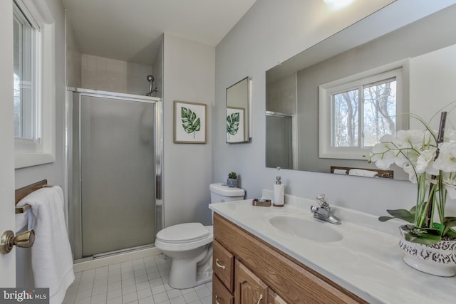 bathroom with tile patterned floors, a shower stall, toilet, and vanity