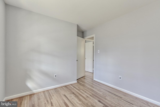 unfurnished bedroom with wood finished floors and baseboards