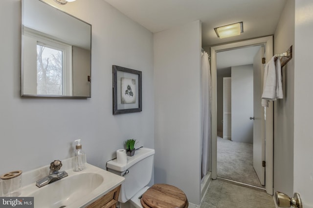 bathroom featuring a stall shower, vanity, and toilet