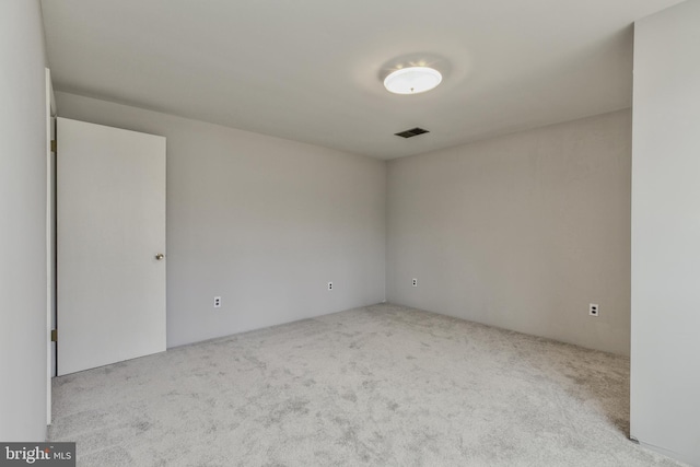 empty room featuring visible vents and carpet flooring