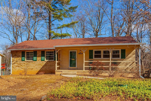 single story home with a porch and brick siding