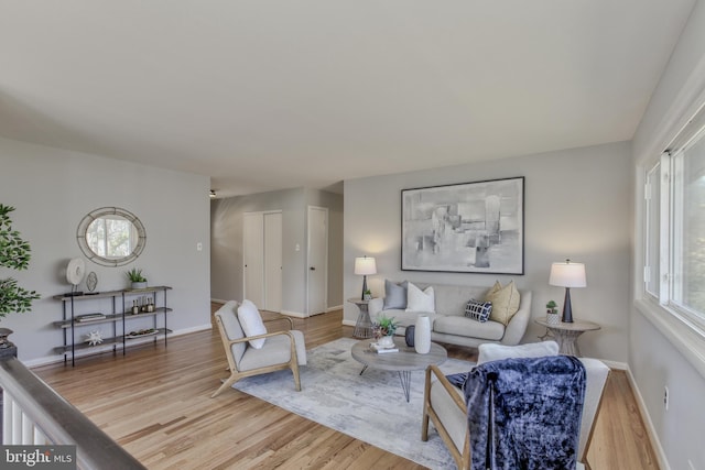 living room featuring light wood finished floors and baseboards