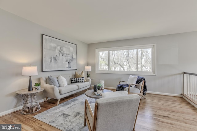 living area with wood finished floors and baseboards