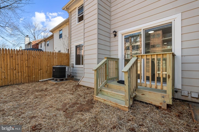 exterior space featuring central AC and fence