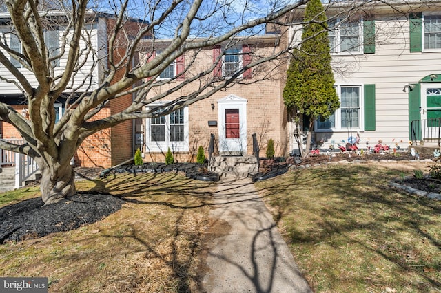 view of front facade featuring brick siding and entry steps