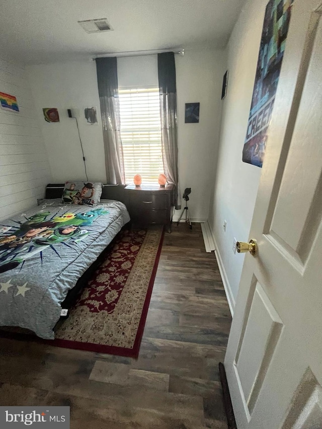 bedroom featuring dark wood-type flooring