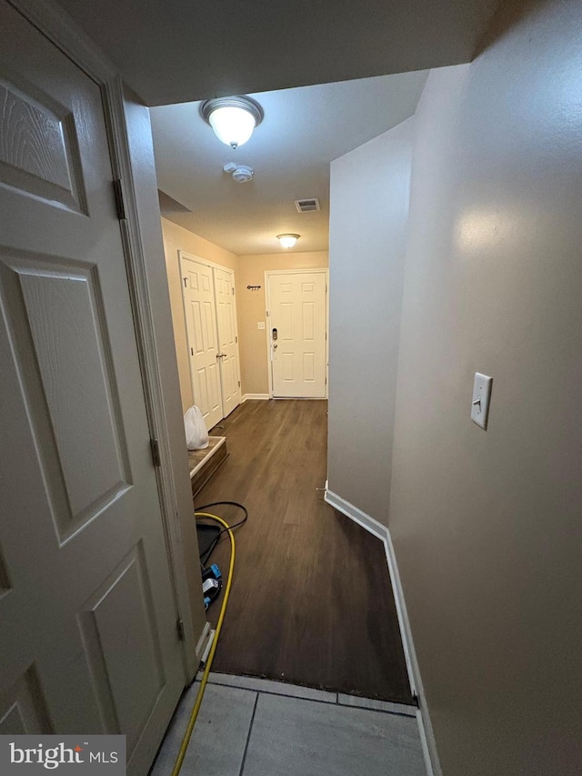 corridor with hardwood / wood-style floors