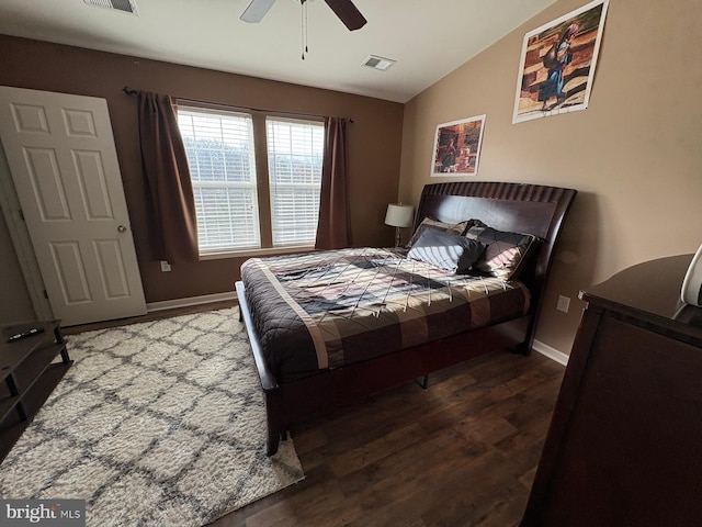 bedroom featuring dark hardwood / wood-style flooring, vaulted ceiling, and ceiling fan