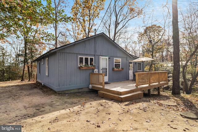 back of house featuring a deck