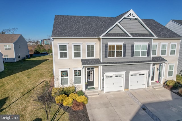 view of front of property with a garage and a front lawn