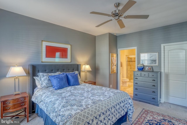 carpeted bedroom featuring ensuite bathroom and ceiling fan