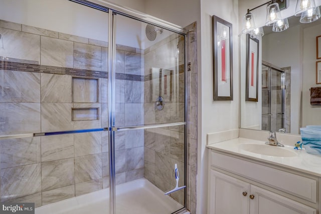 bathroom featuring vanity and an enclosed shower