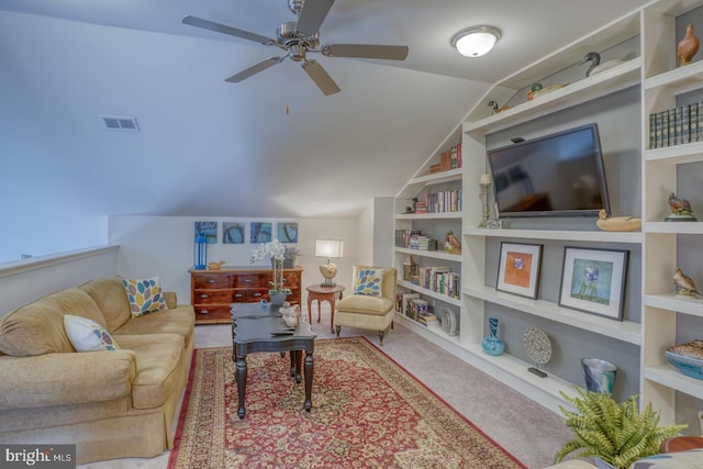 living room featuring ceiling fan, light colored carpet, built in features, and vaulted ceiling