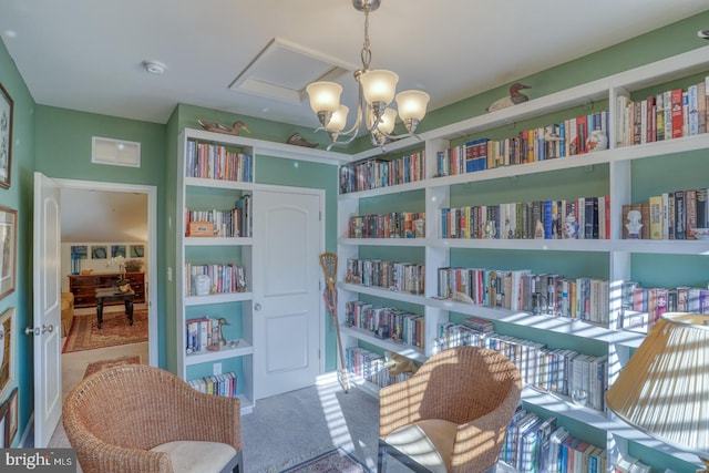 living area with a notable chandelier and carpet floors