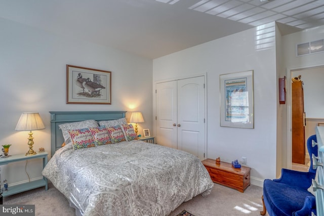 bedroom featuring light carpet and a closet