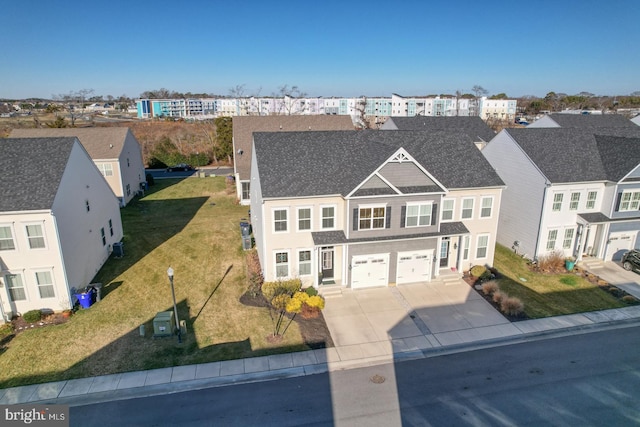 view of front of home with a front yard and a garage