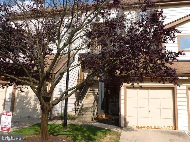 obstructed view of property with a garage