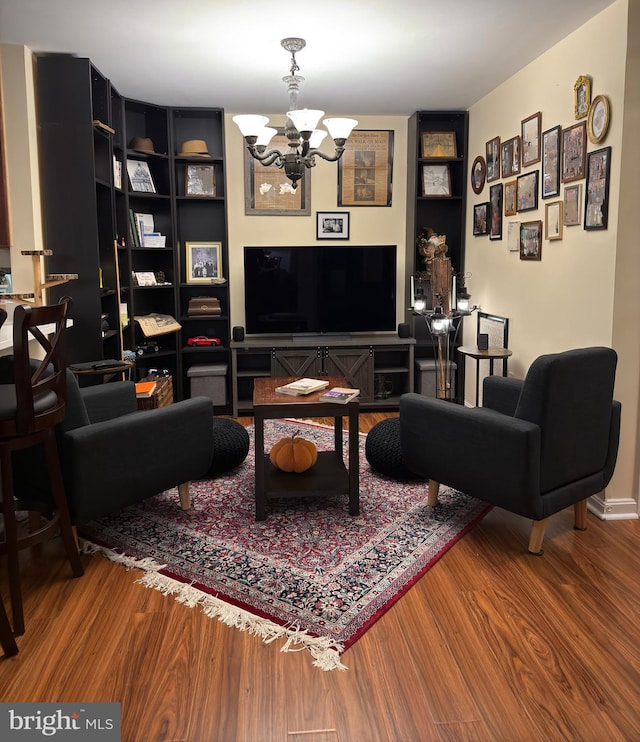 living room with wood-type flooring and a notable chandelier