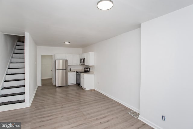 unfurnished living room with light hardwood / wood-style flooring