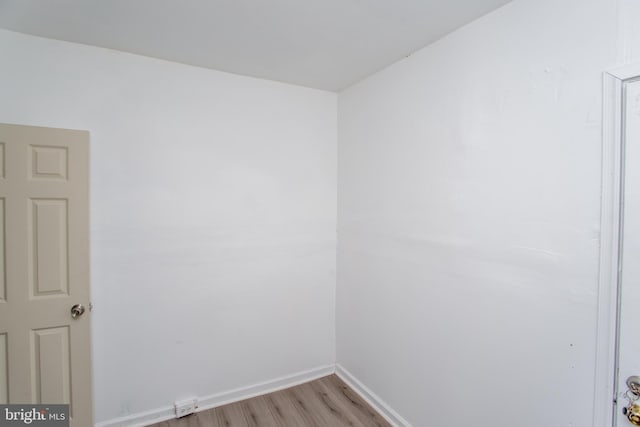 empty room with light hardwood / wood-style flooring