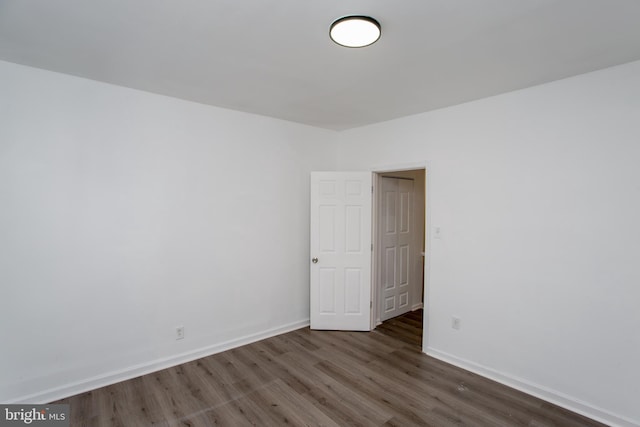 unfurnished room featuring dark hardwood / wood-style flooring