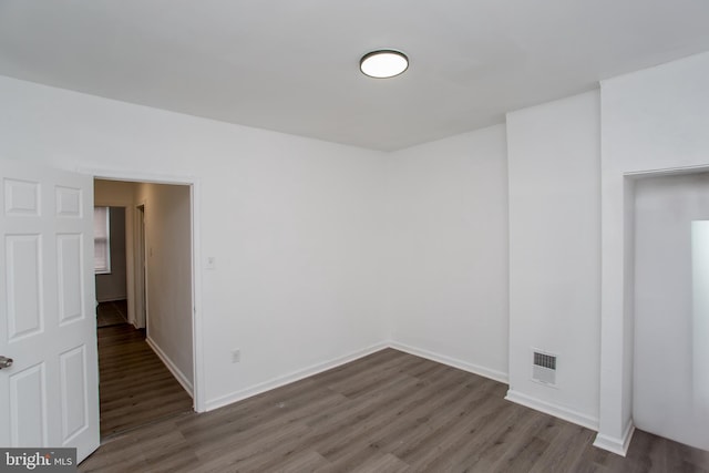 spare room with dark hardwood / wood-style floors