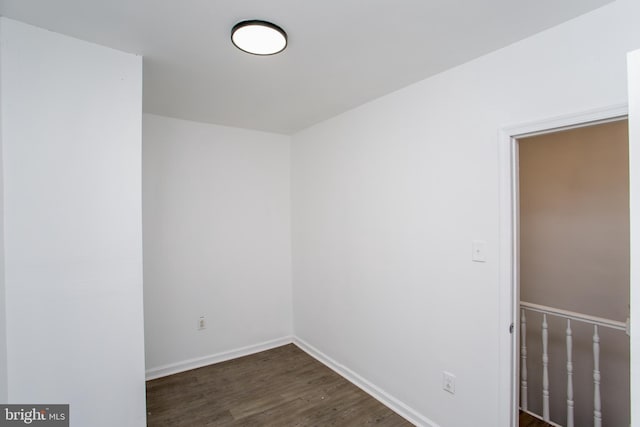 spare room with dark wood-type flooring