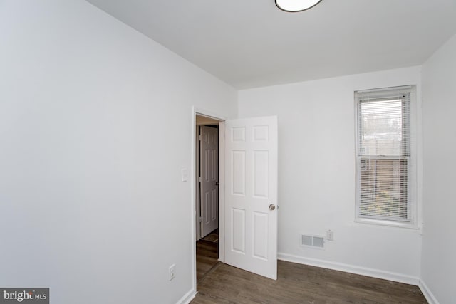 spare room with dark hardwood / wood-style floors