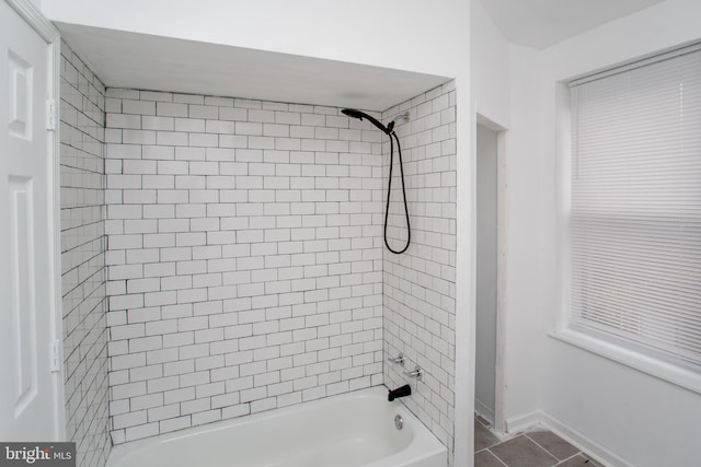 bathroom with tile patterned floors and tiled shower / bath combo