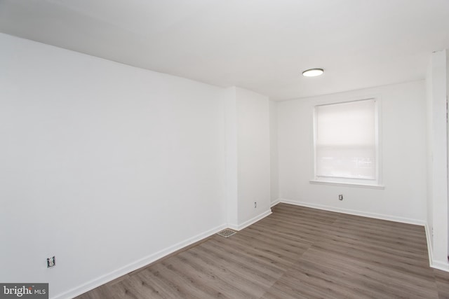 spare room featuring dark hardwood / wood-style floors