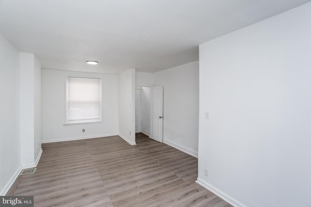 spare room featuring light hardwood / wood-style flooring