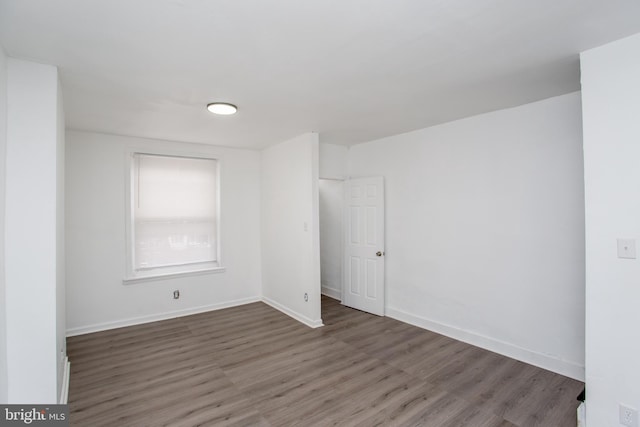 spare room featuring dark hardwood / wood-style floors