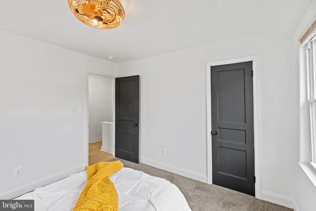 carpeted bedroom featuring multiple windows