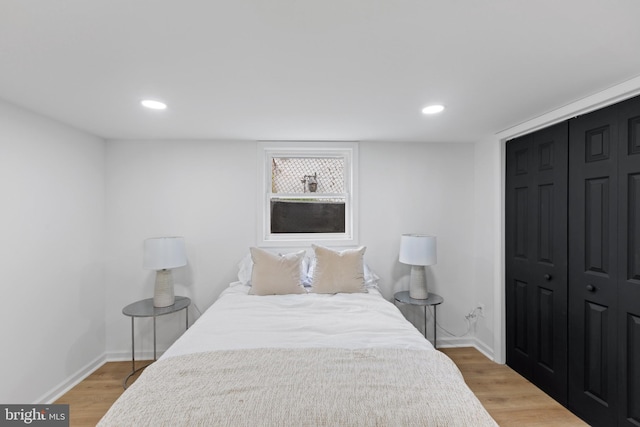 bedroom featuring wood-type flooring and a closet