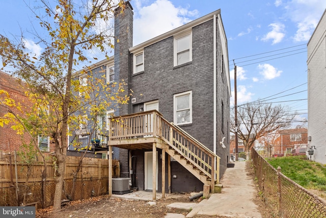 back of property featuring a wooden deck