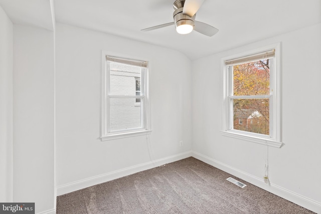 carpeted spare room featuring ceiling fan