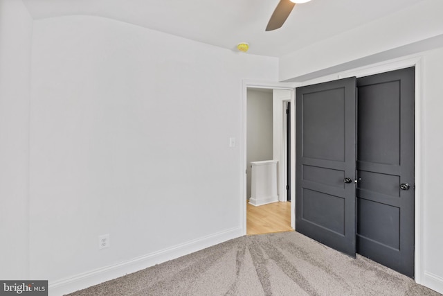 unfurnished bedroom featuring light carpet and ceiling fan