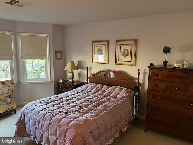 bedroom with light colored carpet