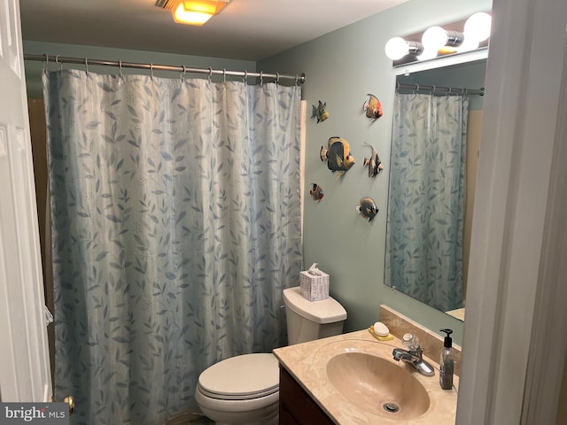 bathroom featuring vanity and toilet