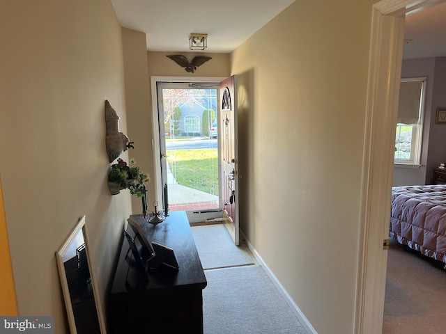 entryway with a healthy amount of sunlight and light colored carpet