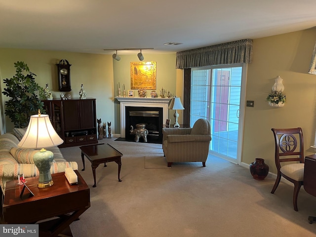 living room with light carpet and track lighting