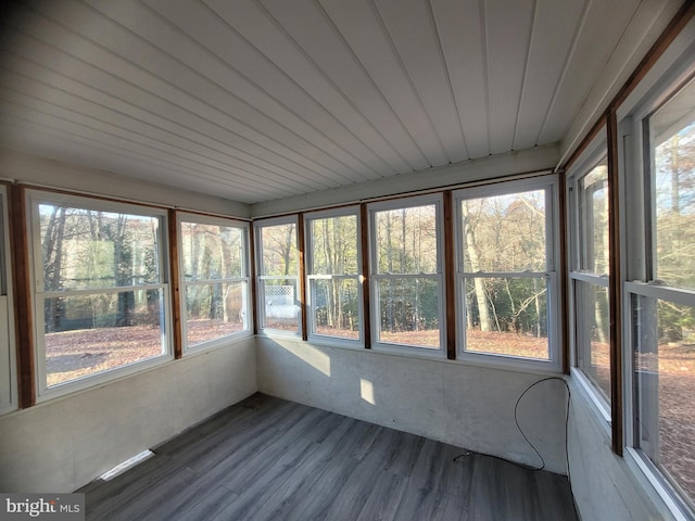 unfurnished sunroom featuring plenty of natural light and wooden ceiling