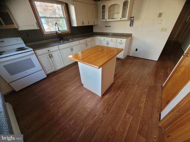 kitchen with butcher block countertops, white cabinets, dark hardwood / wood-style floors, and white electric stove