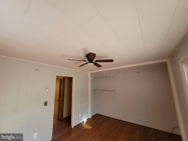 unfurnished bedroom with a closet, ceiling fan, and dark hardwood / wood-style flooring