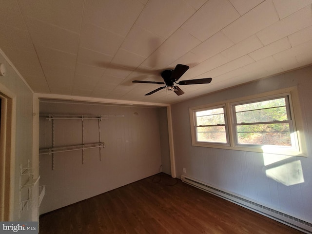 unfurnished bedroom with dark hardwood / wood-style floors, ceiling fan, a closet, and a baseboard radiator