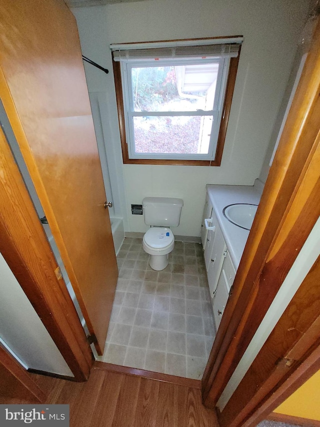 bathroom with vanity, toilet, and wood-type flooring