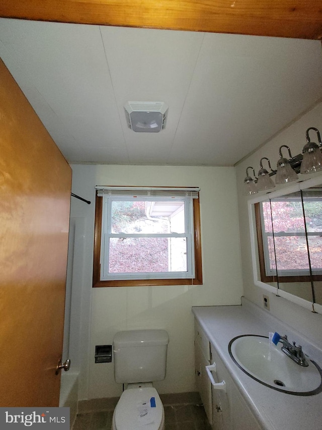 bathroom with tile patterned flooring, a shower, vanity, and toilet